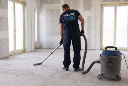 Bauschmutz wird mit einem Industriesauger vom Estrich aufgenommen